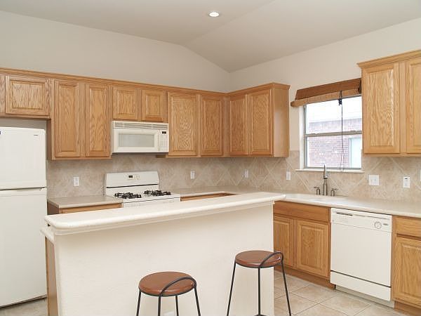 Kitchen with Corian counters, center island, and breakfast area.