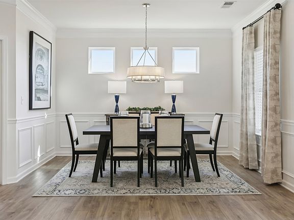 The Avondale- Dining Area. Sample image for illustration upgrades, options, and colors may vary.