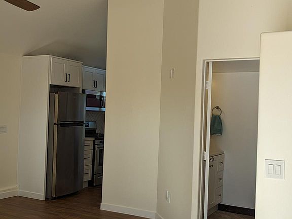 View from front door showing kitchen and bathroom and steps to sleeping loft.