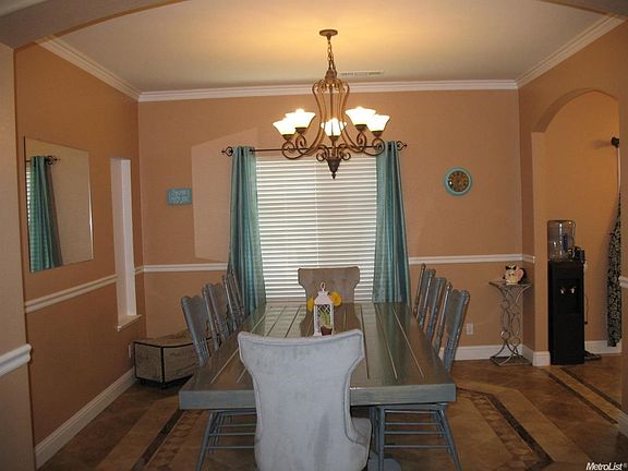 Crown molding, chair rail and beautiful tile flooring highlight the formal dining room it has lots of space for friends and family!