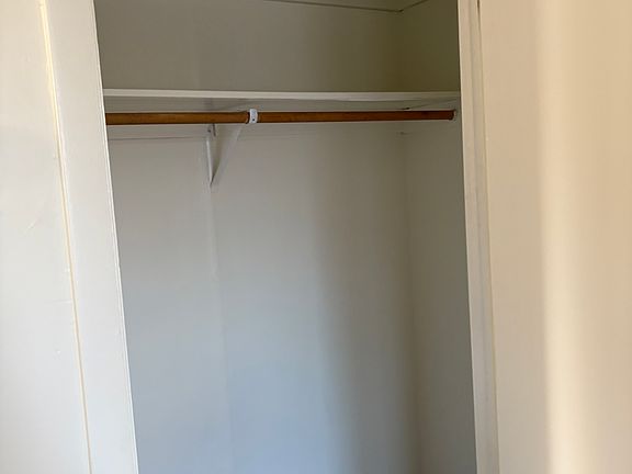 Large lighted walk-in close located in living room.