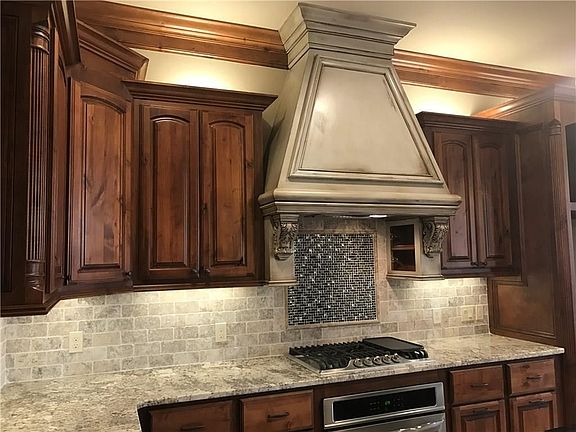 Spice cabinet on interior sides of vent hood.