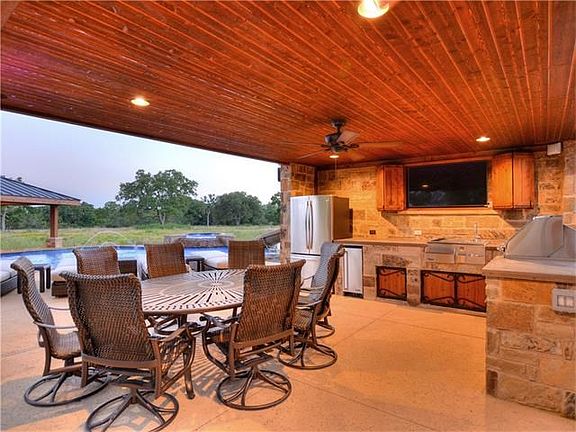 Nothing was missed in this outdoor kitchen! SS appliances, fire up the gas grill, catch up on your Netflix queue on the flatscreen, sipping a beer and cooling off in the pool! Perfect for entertaining out here - PRIVATE!