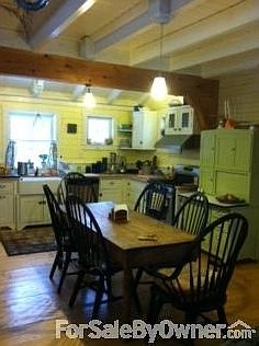 Kitchen has 12' high sloped ceiling
						:
						Heavy timber style throughout house, ship knees framing kitchen entrance