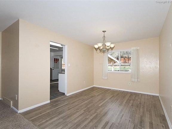 Dining area off the kitchen with a wood laminate floor