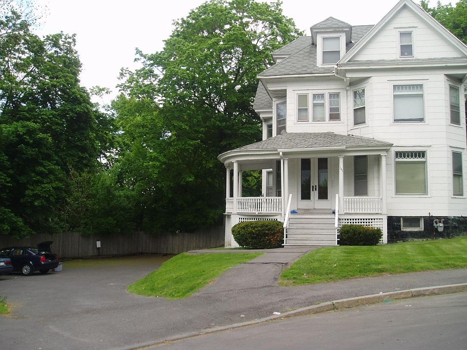 Stately victorian with parking lot on left