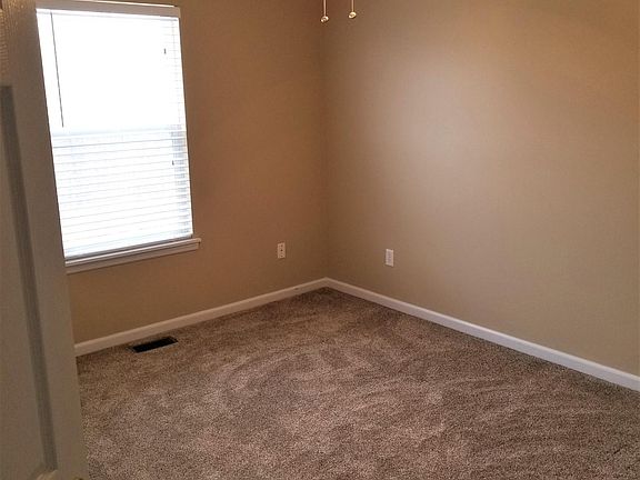 Master bedroom features new carpet, fresh paint, ceiling fan
