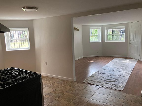 Kitchen partial view + living room