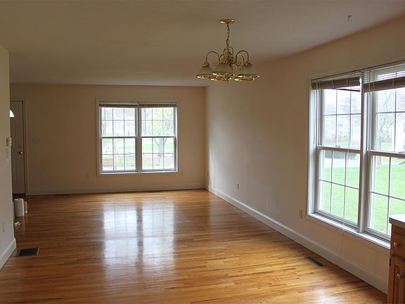 Family Room area with open floor plan. Hardwood Flooring. Unit has Central Air Conditioning.