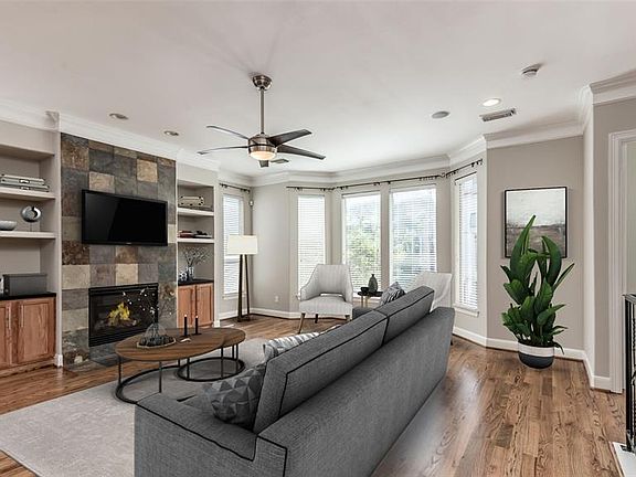 Second floor Living Room is light-filled and sure to impress! Recent refinished hardwoods on this level and recent fresh paint on walls throughout the home. Windows face out over street and treetops of the neighborhood. Photo virtually staged.