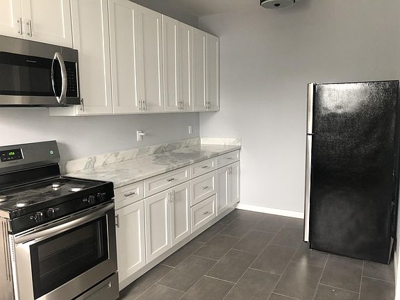 New kitchen with new tile floor, quartz counter tops, appliances and cabinets.