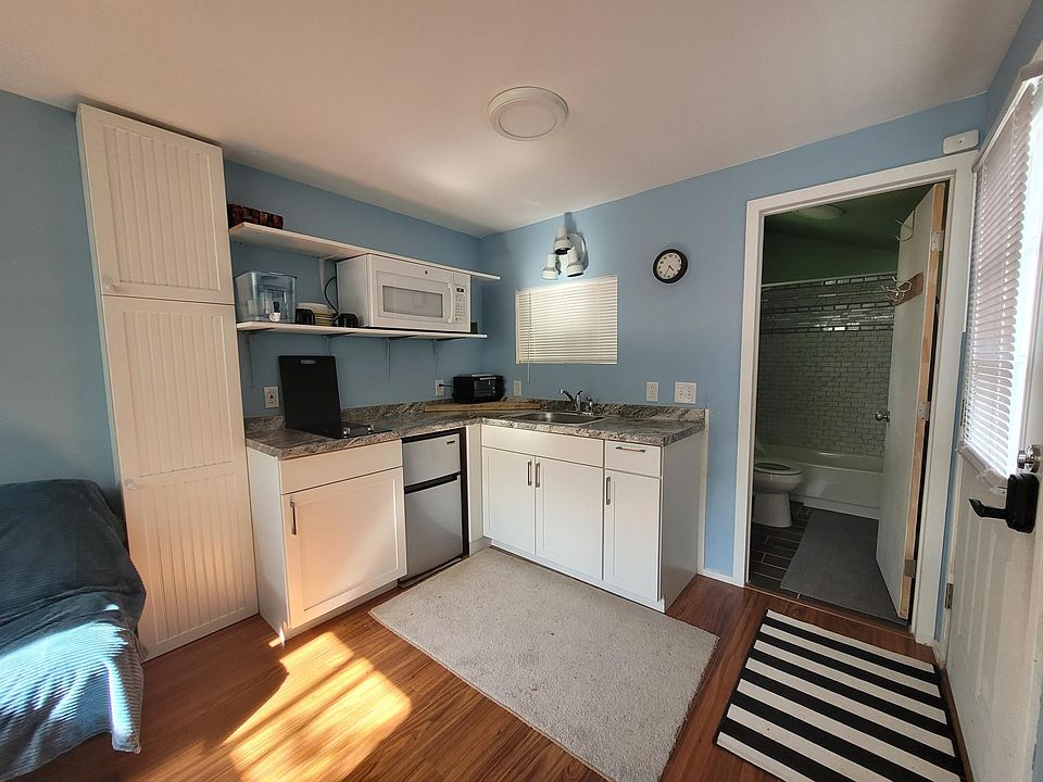 Micro kitchen with fridge, burners, and microwave