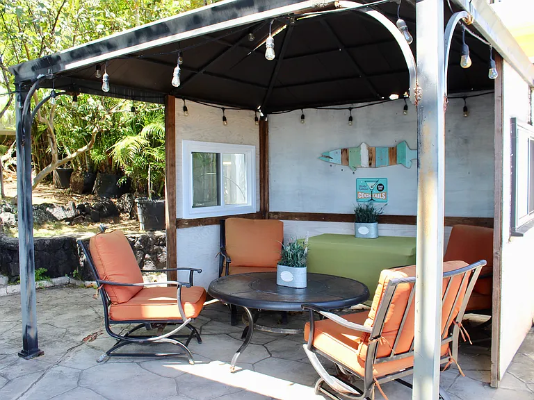 Cabana area next to pool and separate TV area.