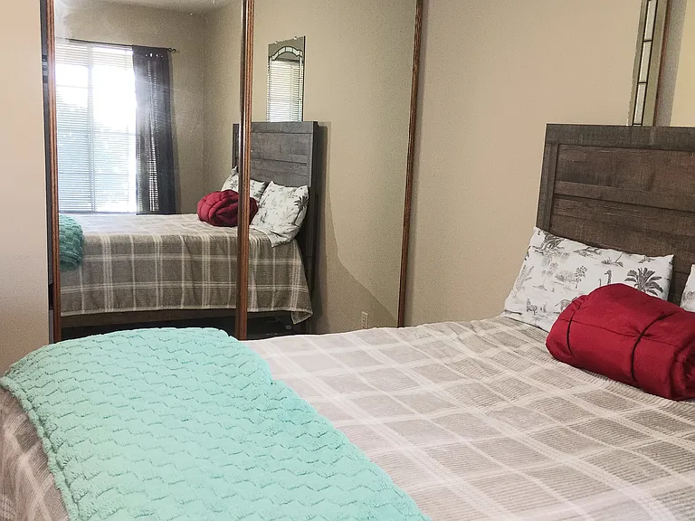Third bedroom with mirror closet doors