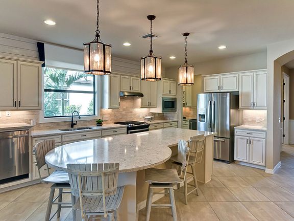 Kitchen with rounded island and stainless steel appliances