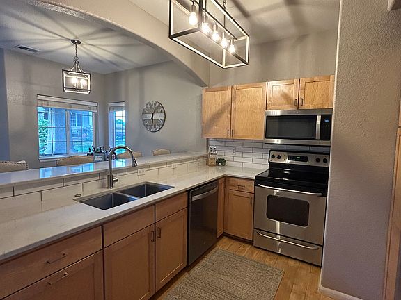 Kitchen with quartz counters and stainless steel appliances