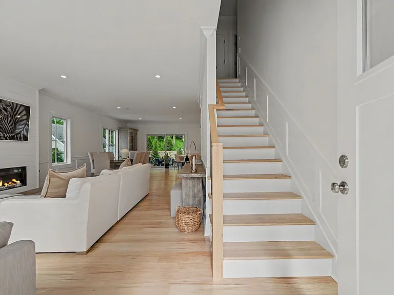 Views to an open floor plan and second level staircase.