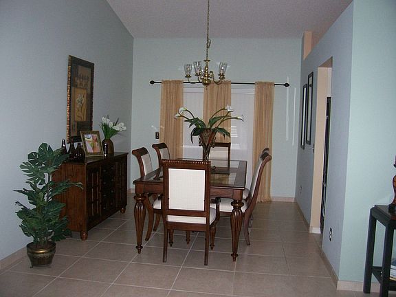 Standing at the front door. Dining room with sliding glass door to porch. 