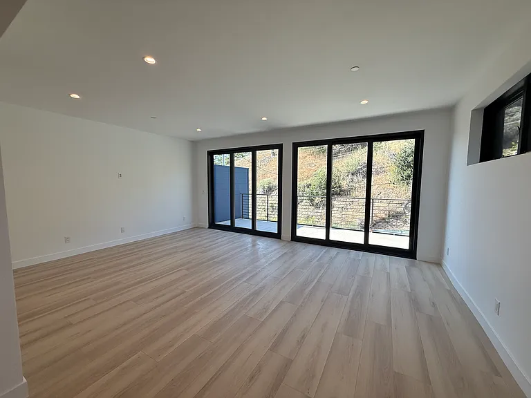 Massive living room with 2 sliders that go to a large, private balcony