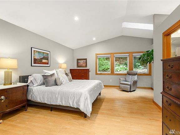 Main level master retreat with vaulted ceiling and skylight.