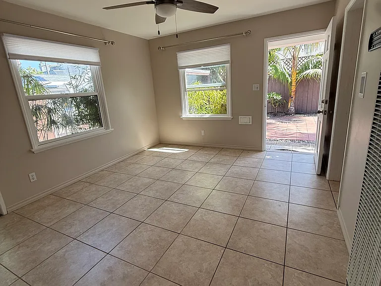Bare living room. All windows and doors in this property open onto the private and attractive property for you to enjoy being inside or outside..