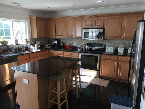 Kitchen with black tile floor and backsplash