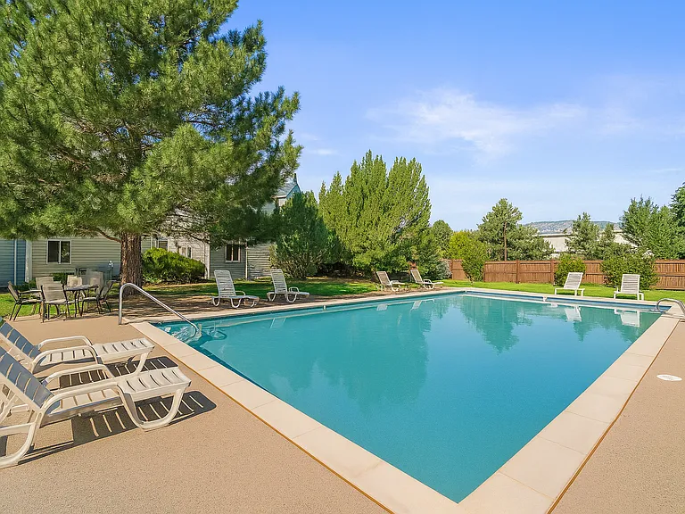 Take a refreshing dip in the pool, surrounded by greenery and mountain views_perfect for relaxing under the Colorado sun.
