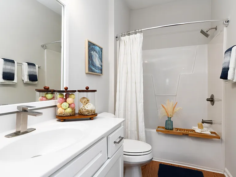 Bright bathroom with quartz counters and bathtub