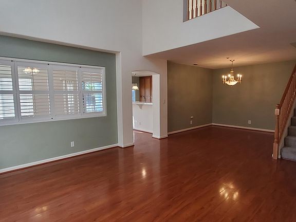 Living room with high ceiling. Open wall to family room