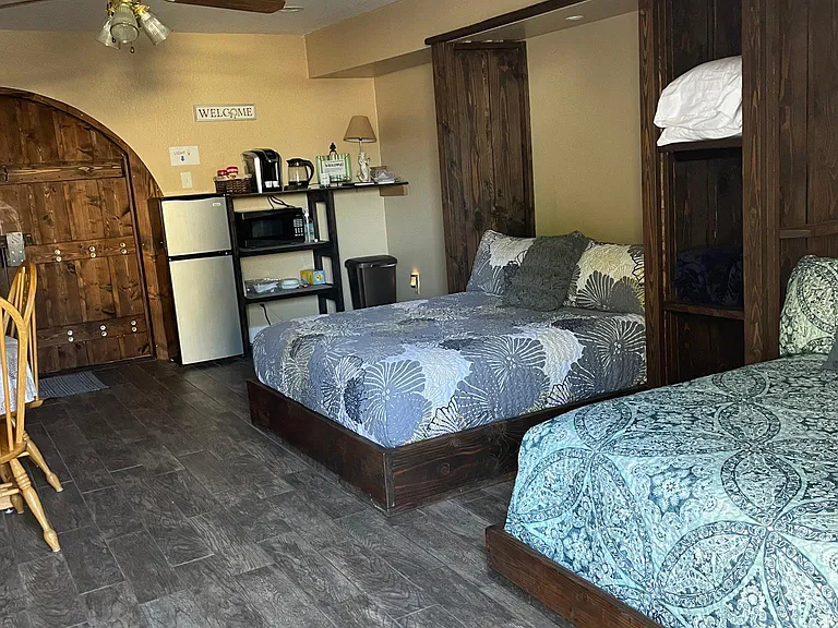 Bedroom 1: Mother-in-law Suite 
This is a huge room with two beds, a private entry, a private bathroom, a private patio, a mini kitchenette area, a tv, and a fireplace. We use this room as a guest room, and it's basically a tiny house.
