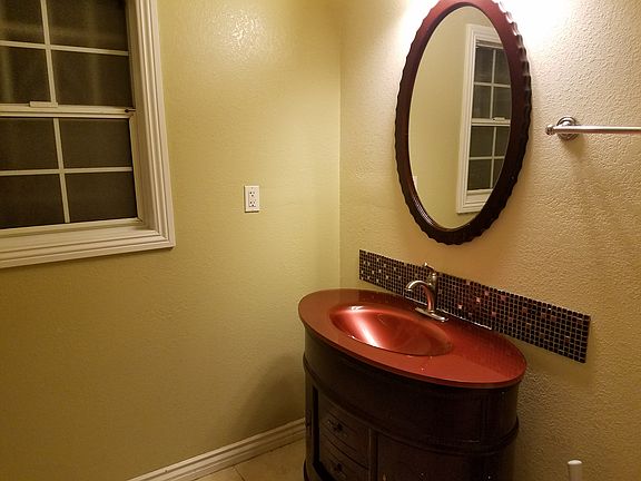 Front Bathroom with step in shower, sink and toilet.