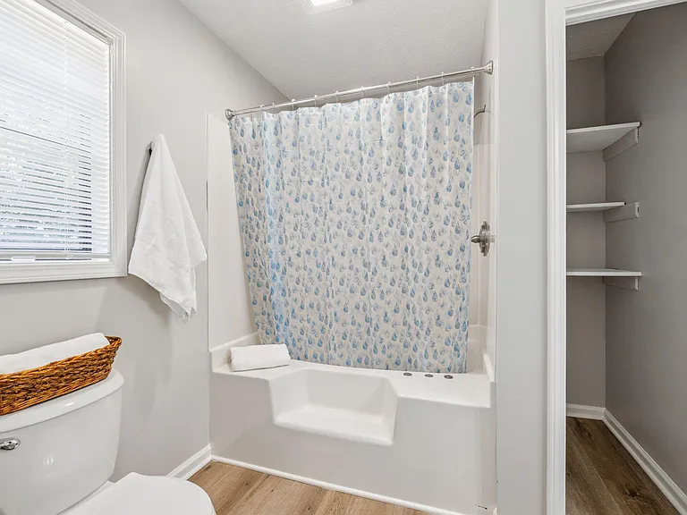 Private bath with large soaking tub and extra storage.