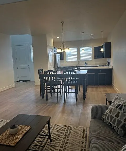 Spacious living room decorated. Dining room with table and chairs.
