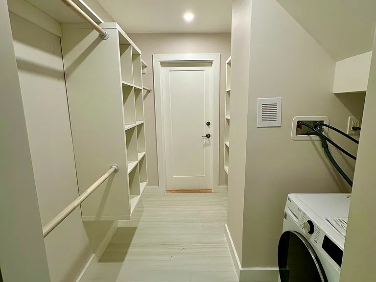 Spacious walk-in closet with washer-dryer