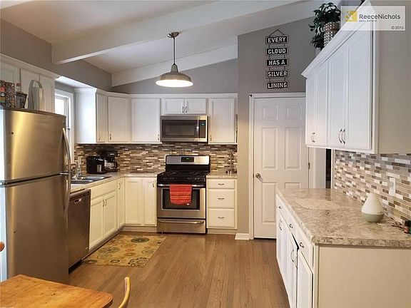 Gorgeous new kitchen offers new cabinets, counter tops, glass tile backsplash, new plumbing and lighting fixtures, deep double sink, stainless appliances, and awesome refinished hardwood flooring.