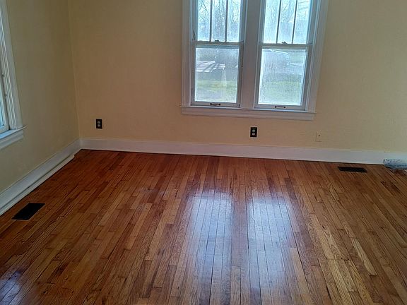 Spacious living room with wood floor.