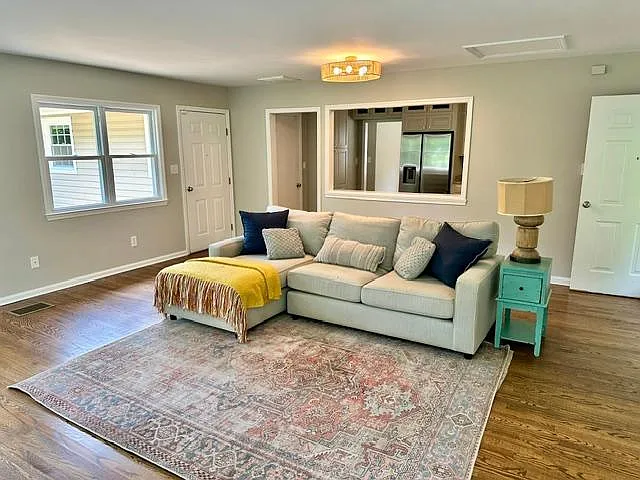 Large sunny living room with door to the big outdoor deck.