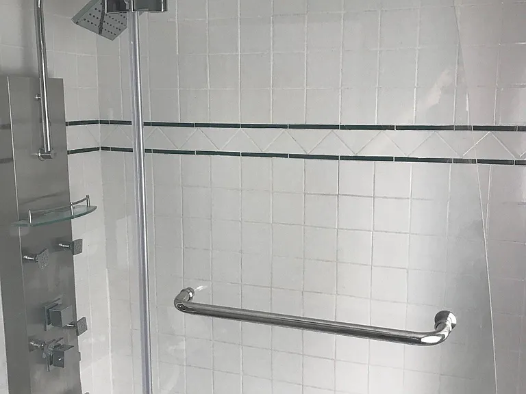 Tiled enclosure with deep tub upstairs.