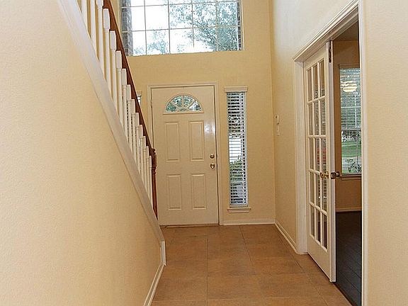 Extended tile entry with abundance of natural light , study room with French doors to the right.
