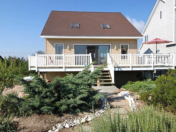 View of home from the bay.  Oversized slider, huge deck and charming private walkway to the beach.