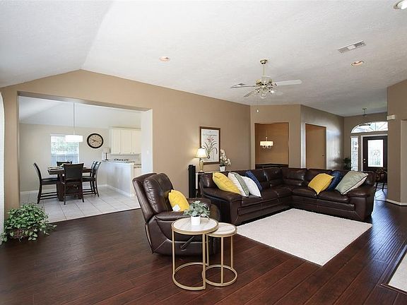 This family room view shows open concept into the breakfast room, kitchen bar and formal dining. French doors open to the backyard on the left, front foyer on your right. Natural light floods in showing off these beautiful new floors.