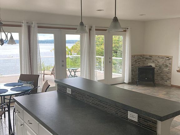 Living Area with gas fireplace and French Doors to waterfront deck.