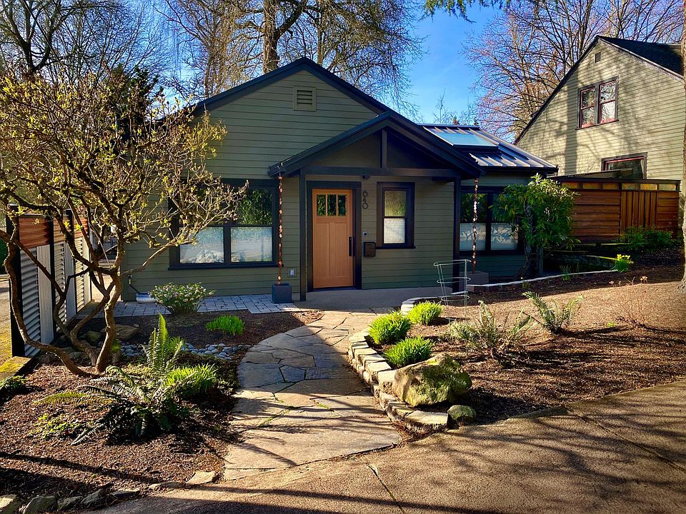 Slate walk-way, privacy fence, covered entrance, metal roof, living room skylight.