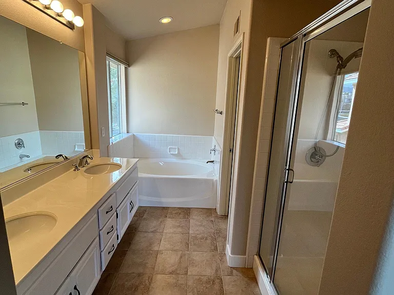 Large master bath with dual sinks, walk in shower, and soaker tub