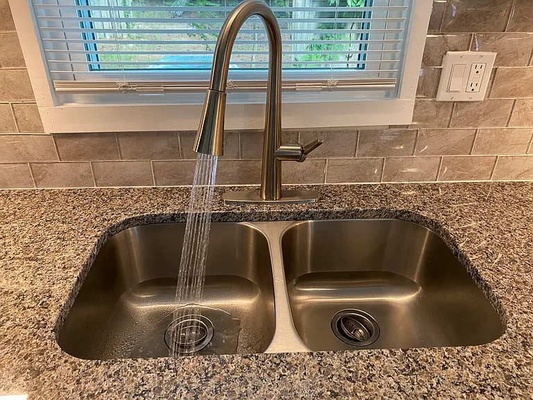 Deep stainless steel sink with LED shower stream.