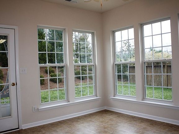 Surrounded by windows in the breakfast room with ceiling fan.