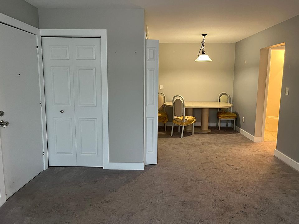 Entry door, living room, dining room, entry closet, extra closet, and entry to bedrooms.