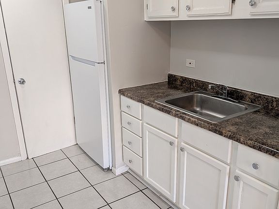 KITCHEN WITH NEW CABINETS AND REFRIGERATOR