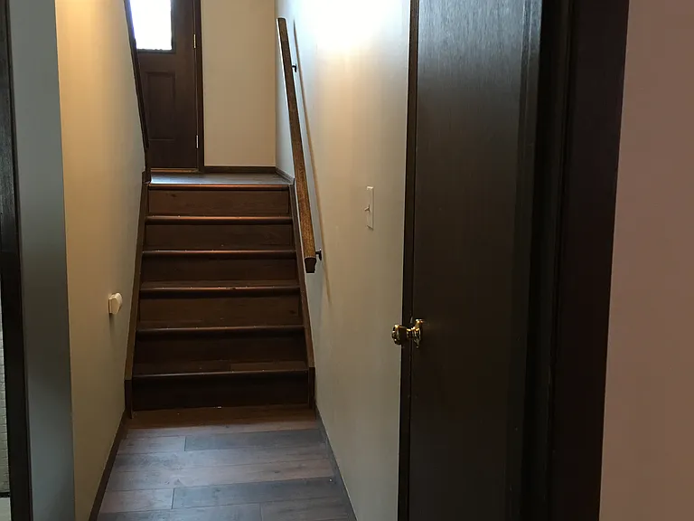 Hallway to ground level - garage, bedroom 3 and basement.