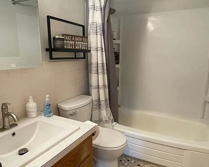 Step into modern convenience with this stylish bathroom featuring sleek fixtures, ample storage, and a calming color palette. Embrace comfort and functionality in every detail. Schedule a tour today to see your new home!